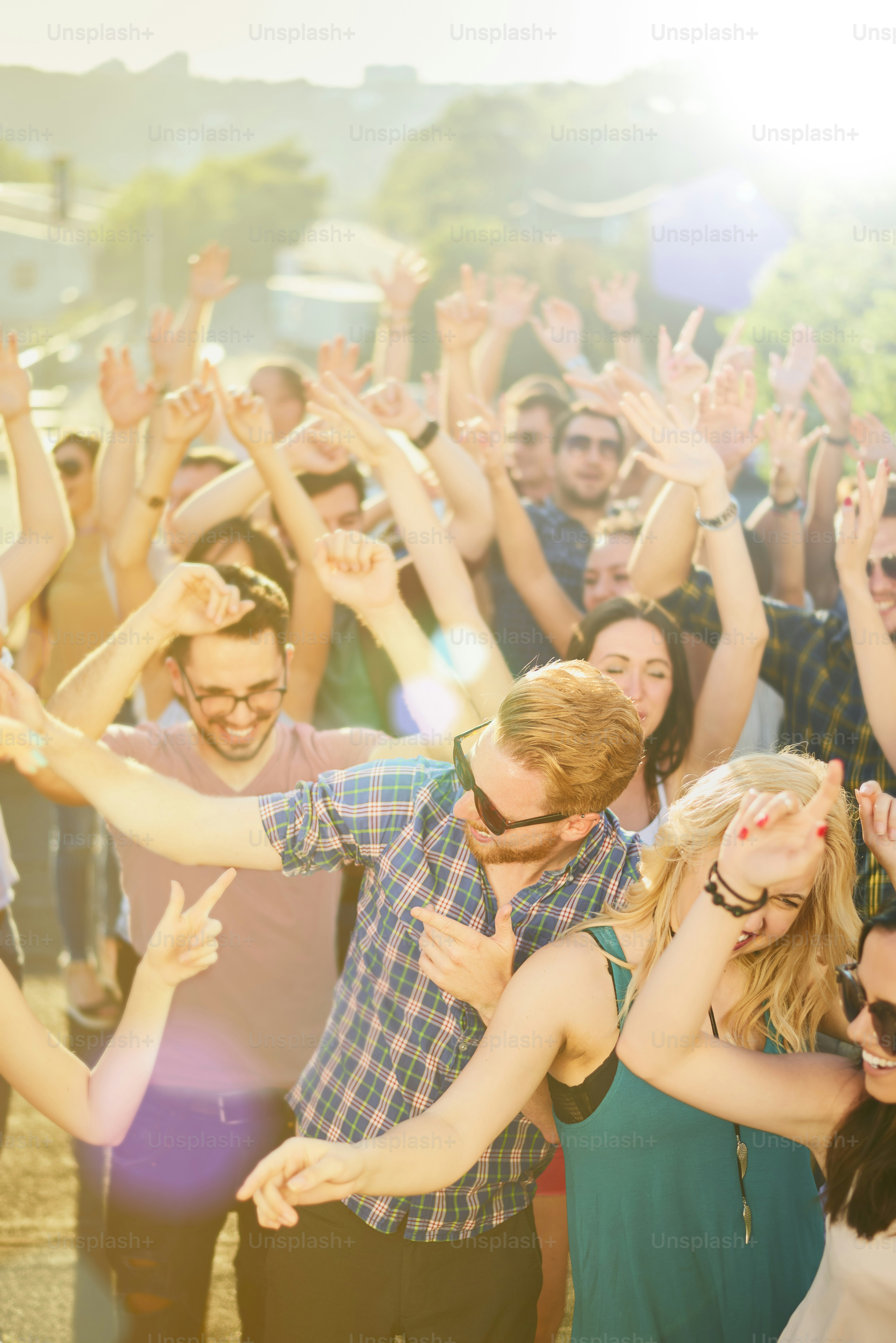 Crowd of people at music festival dancing and enjoying music