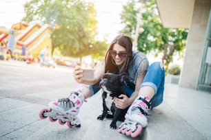 Urban portrait of beautiful and attractive girl with French bulldog and sunglasses. Warm summer colors and haze. Strong back light.