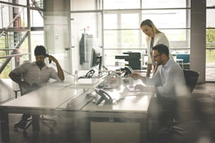 Business people working Business people together in office. Colleague reading document. African business man using Landline.