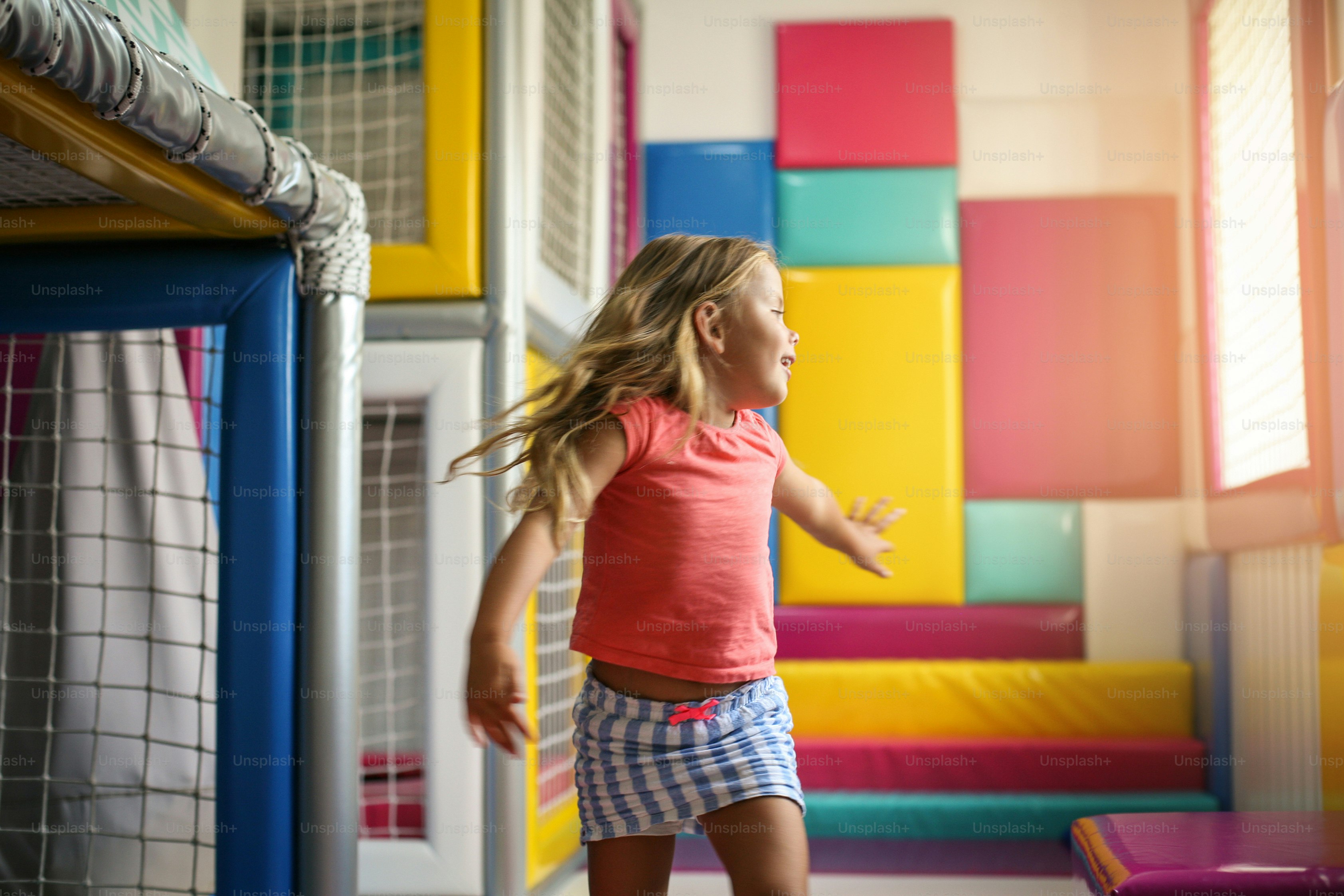 Little girl in playground. Caucasian happy girl with open arms turns in to circle.