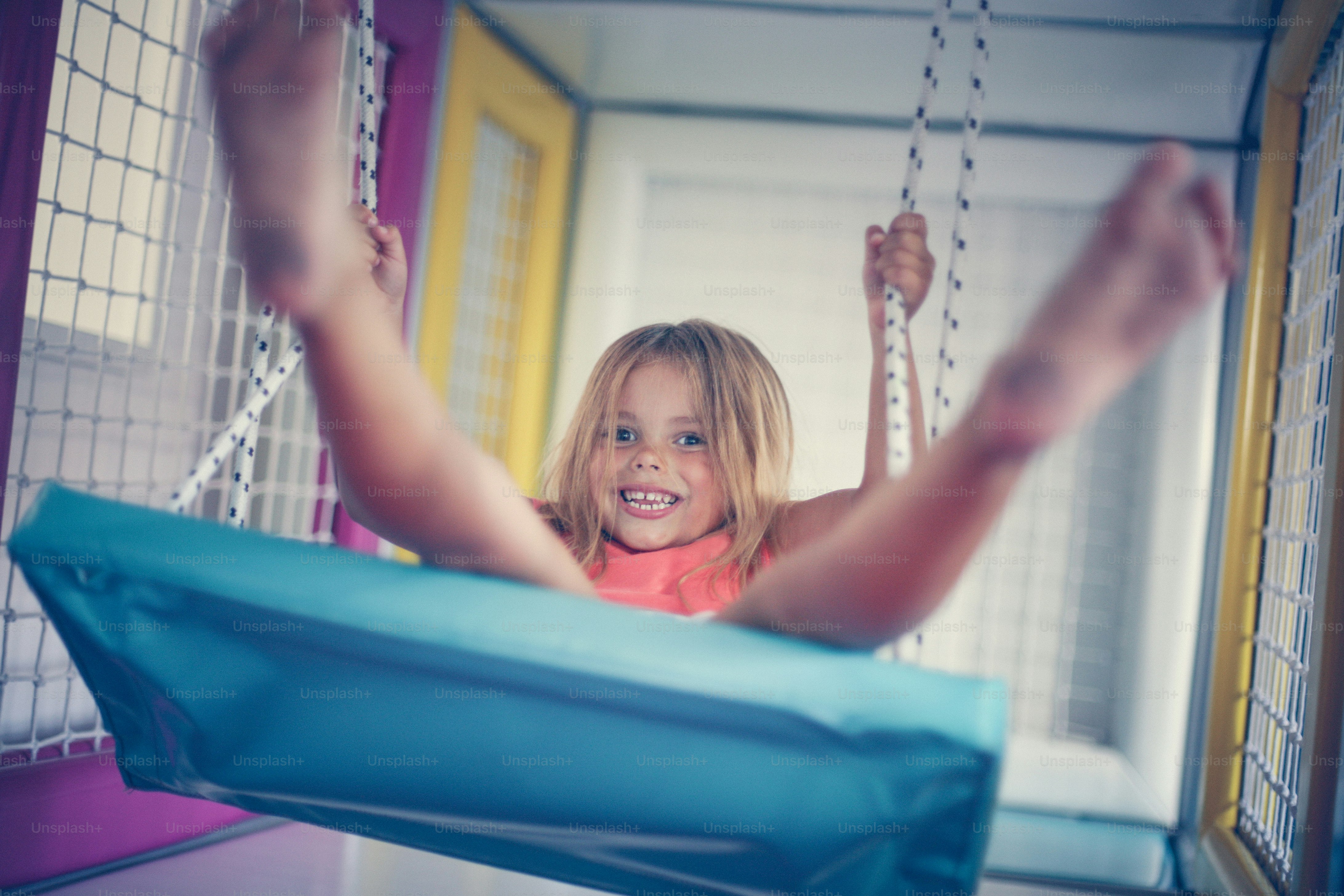 Little girl in playground. Girl is rocking on the swing.