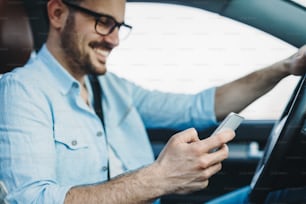 transportation concept - man using phone while driving the car
