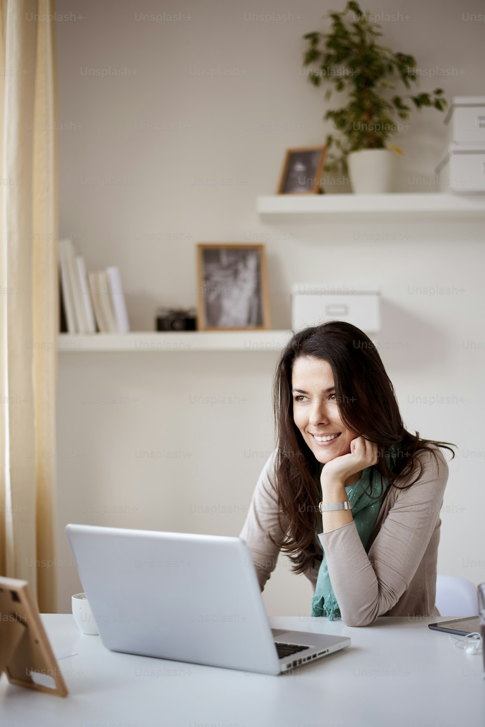Businesswoman using laptop computer at home office/ self employ woman in thirties
