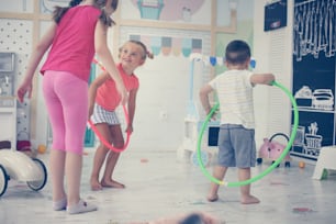 Two children in playground. Children spins hoolahope.