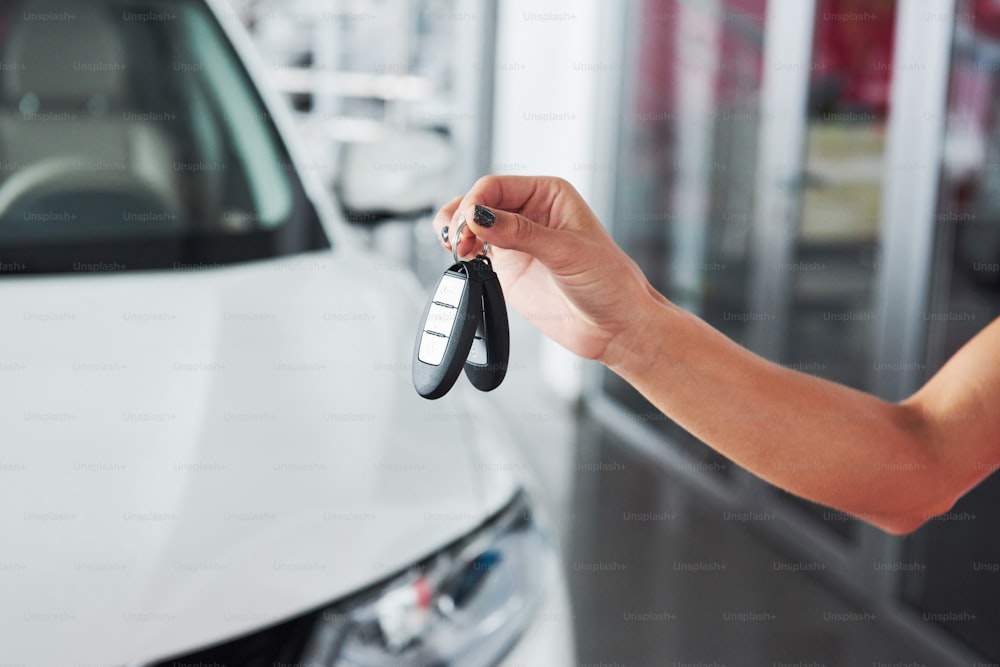 Passing car keys. Cropped closeup of a car dealer holding out car keys to the camera copyspace car dealership salon manager salesman selling buying giving owner profession purchase vehicle concept.