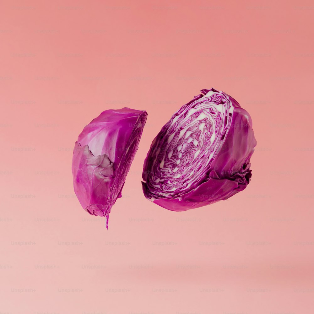 Red cabbage sliced on pastel pink background. Minimal fruit concept.
