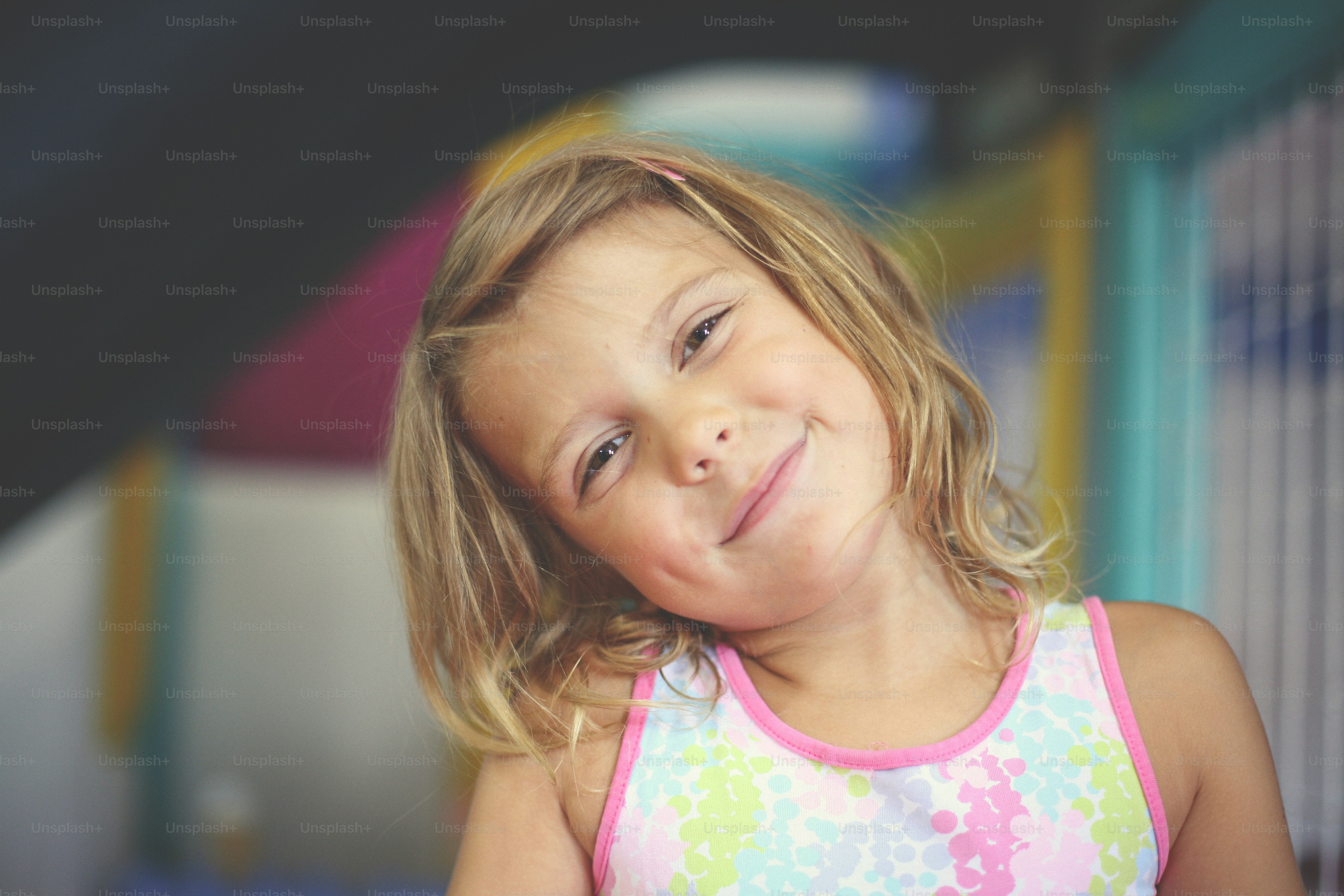 Little girl in playground. Caucasian girl looking at camera.