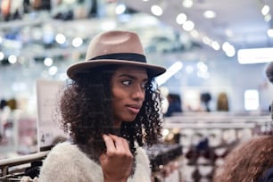 Black young woman doing shopping in a store