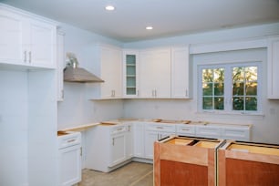 Custom kitchen cabinets in various stages of installation base for island in center