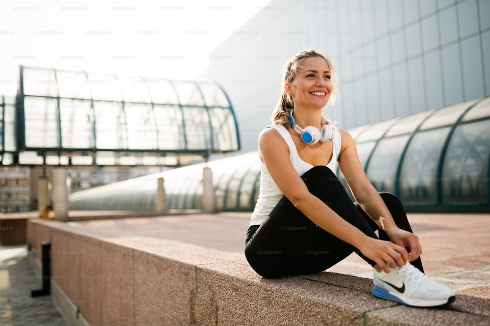 Picture of young attractive happy fitness woman on break
