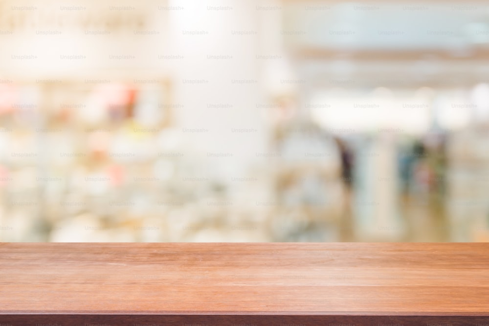 Wooden board empty table blurred background. Perspective brown wood table over blur in department store background, Panoramic banner - can be used mock up for montage products display or design.