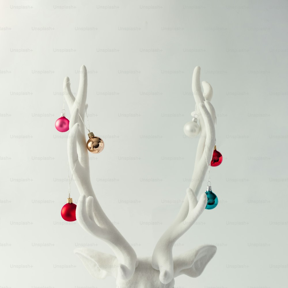 White Christmas reindeer head with antlers with christmas baubles. New Year concept.