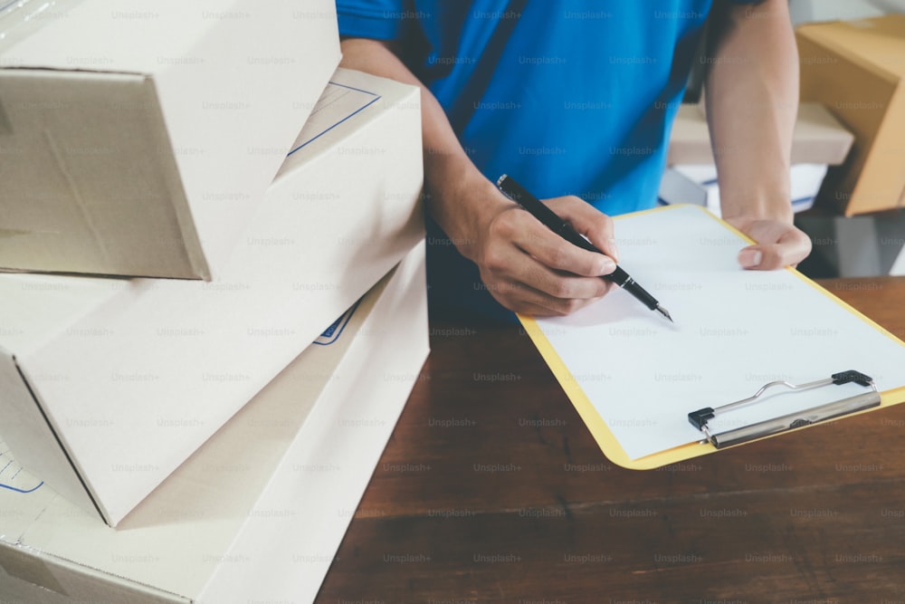 Courier making notes in delivery receipt.