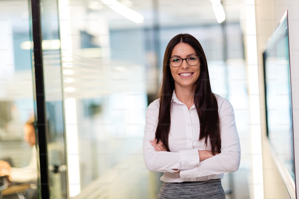Portrait of young attractive businesswoman posing in office