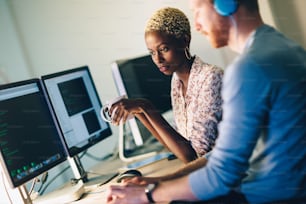 Young software engineers working on project and programming in company