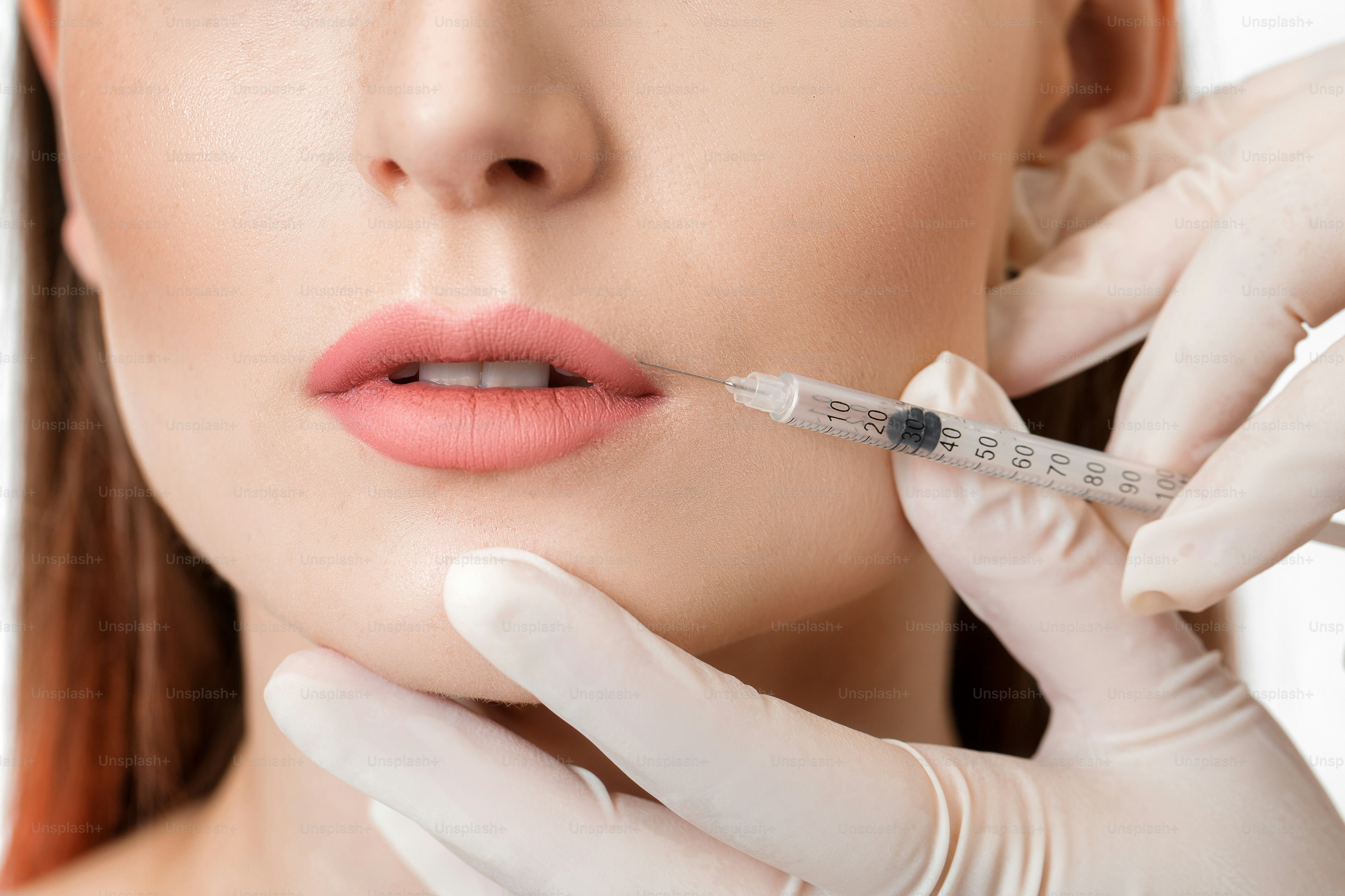 Portrait of beautiful woman getting injection on lips. beauty injections and cosmetology