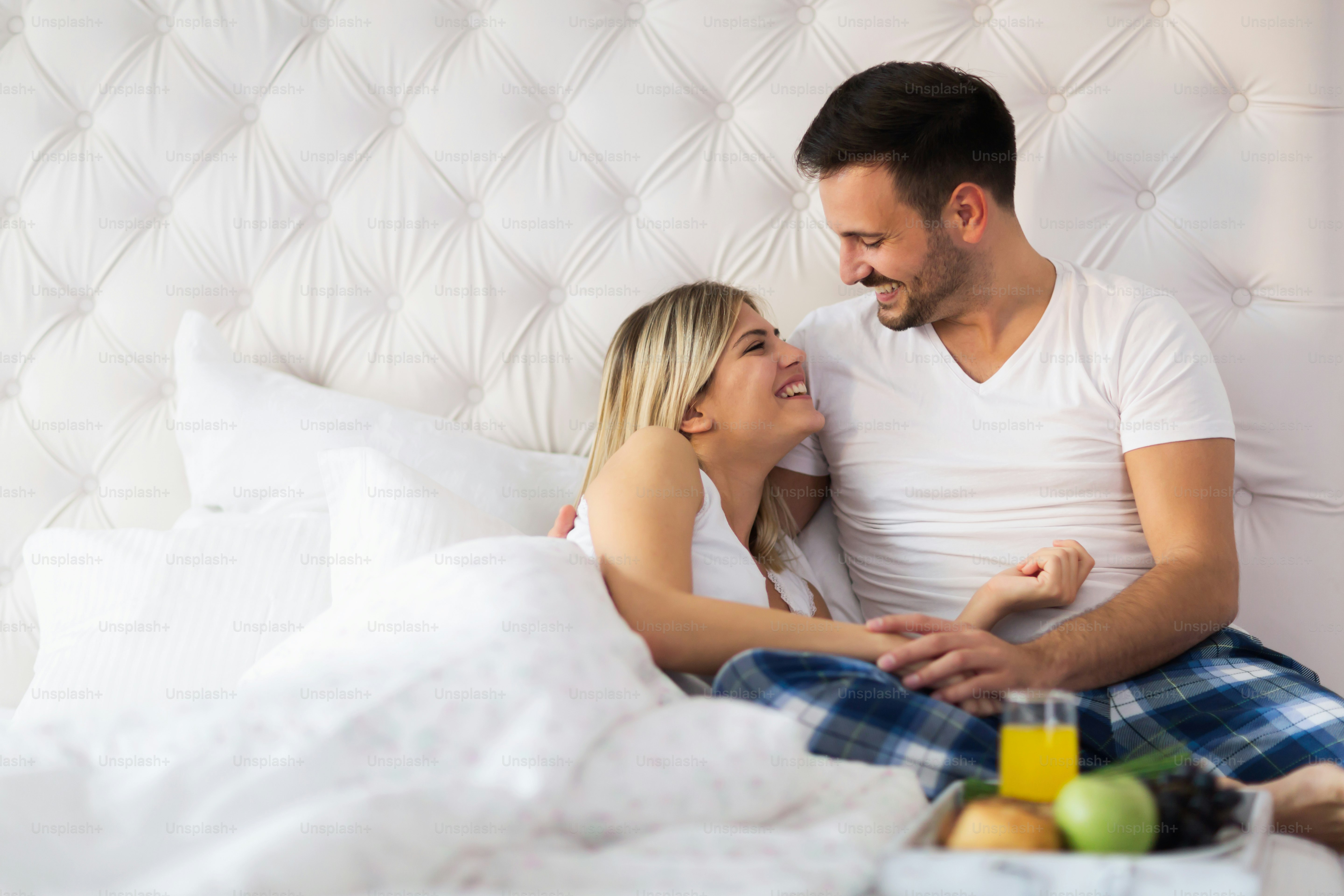 Romantic young happy couple having breakfast in bed