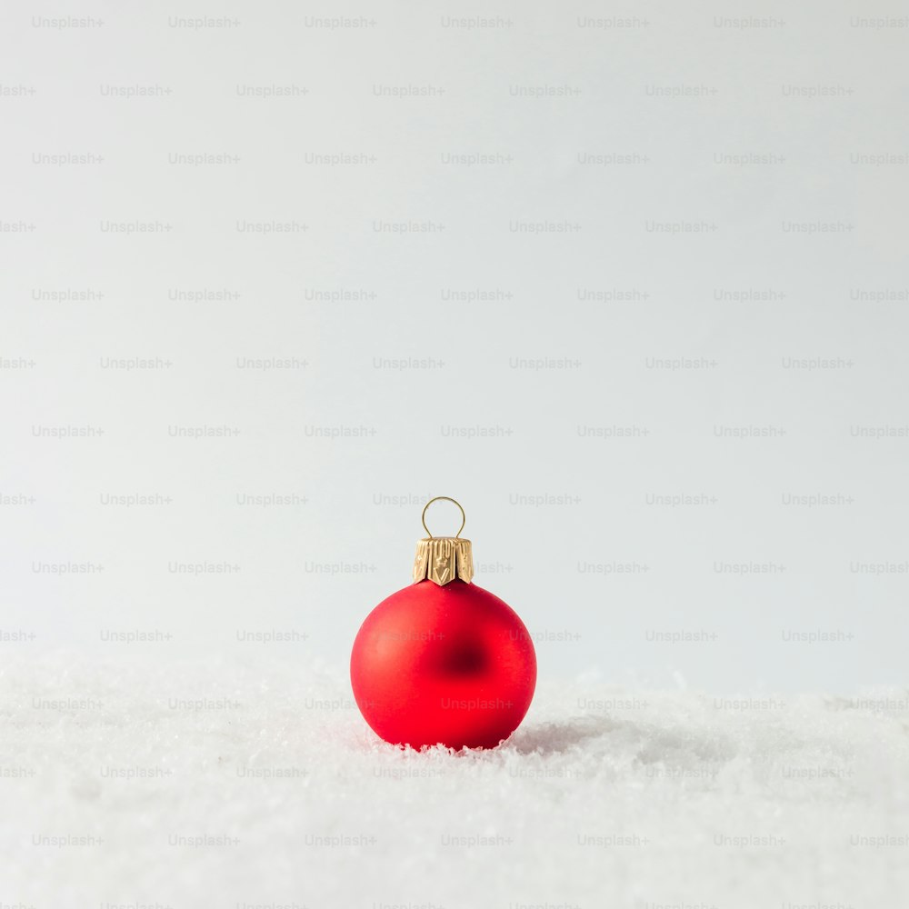 Creative layout made of Christmas bauble decoration on snow. Holiday background.