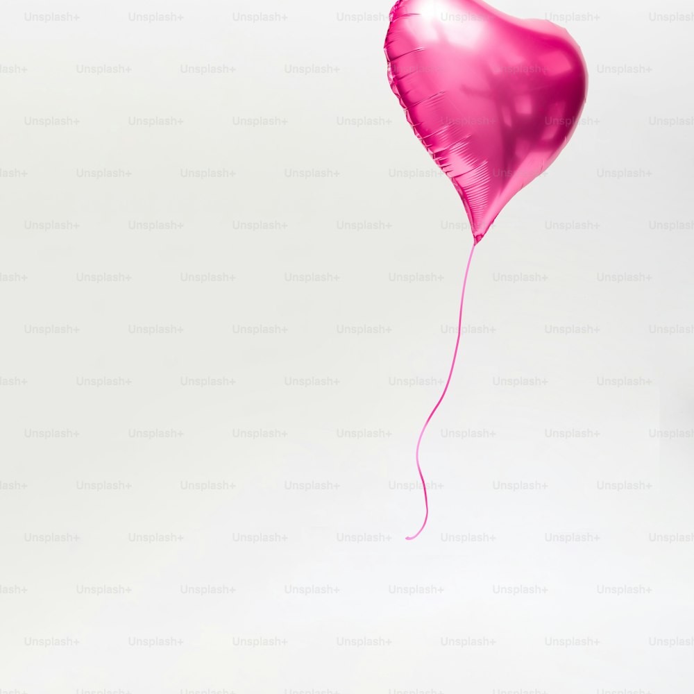 Heart shaped balloon floating away. Minimal love concept.