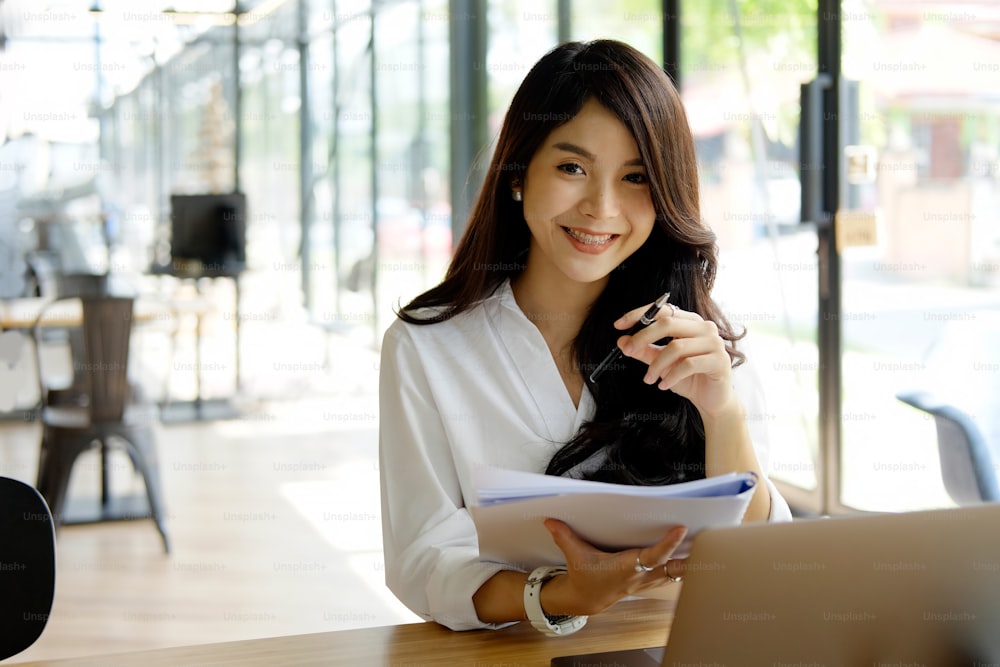 Shot of an attractive young woman sitting at home in front of her laptop