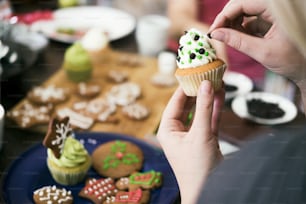 Decorating homemade cupcake for christmas.