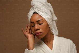 Portrait of young African woman wrapped in towels.