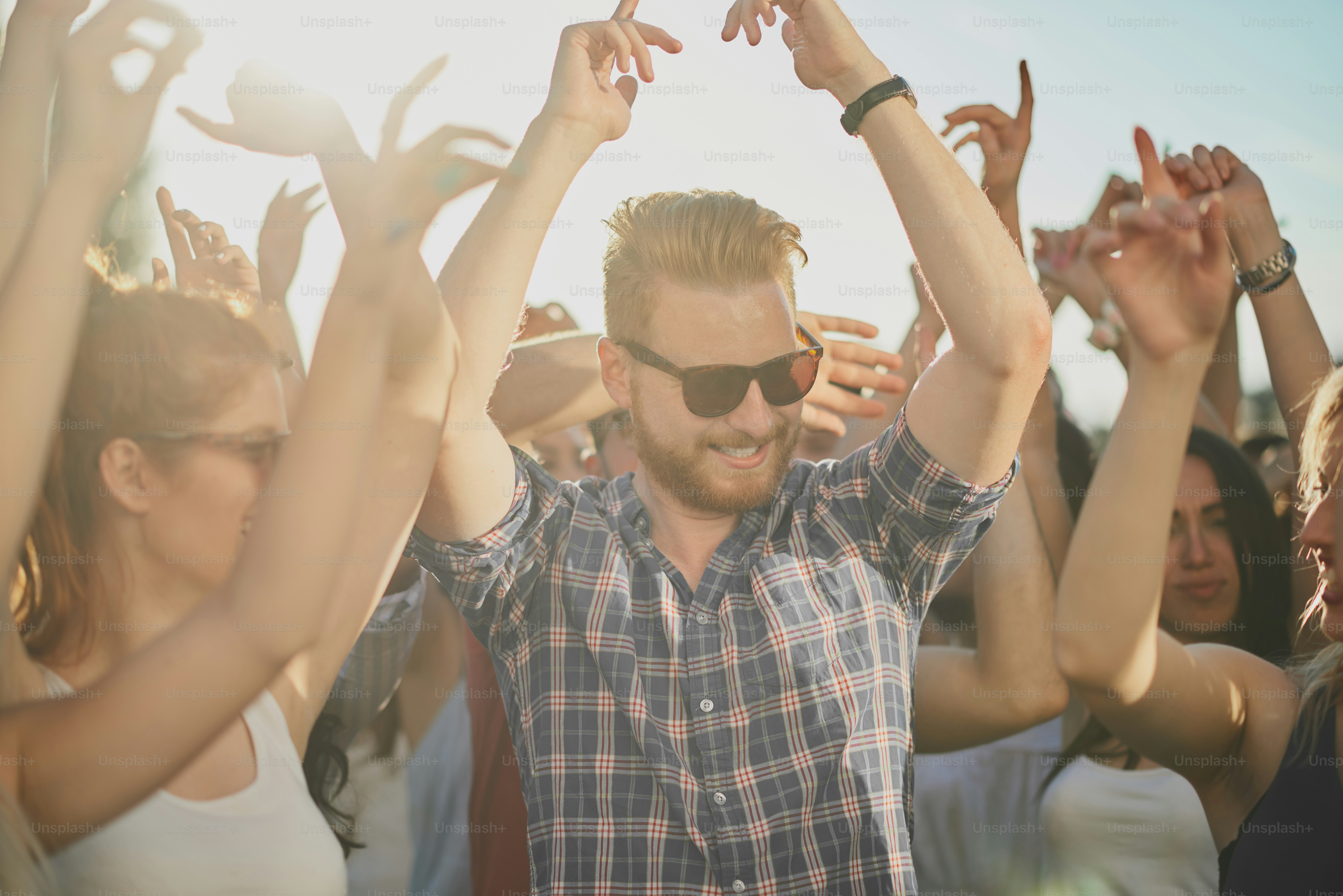 Group of people dancing and having a good time at the outdoor party ...