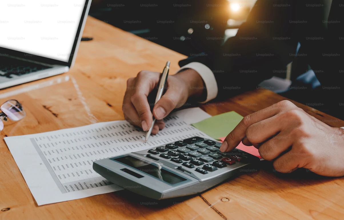 Person calculating how to protect large bank balances