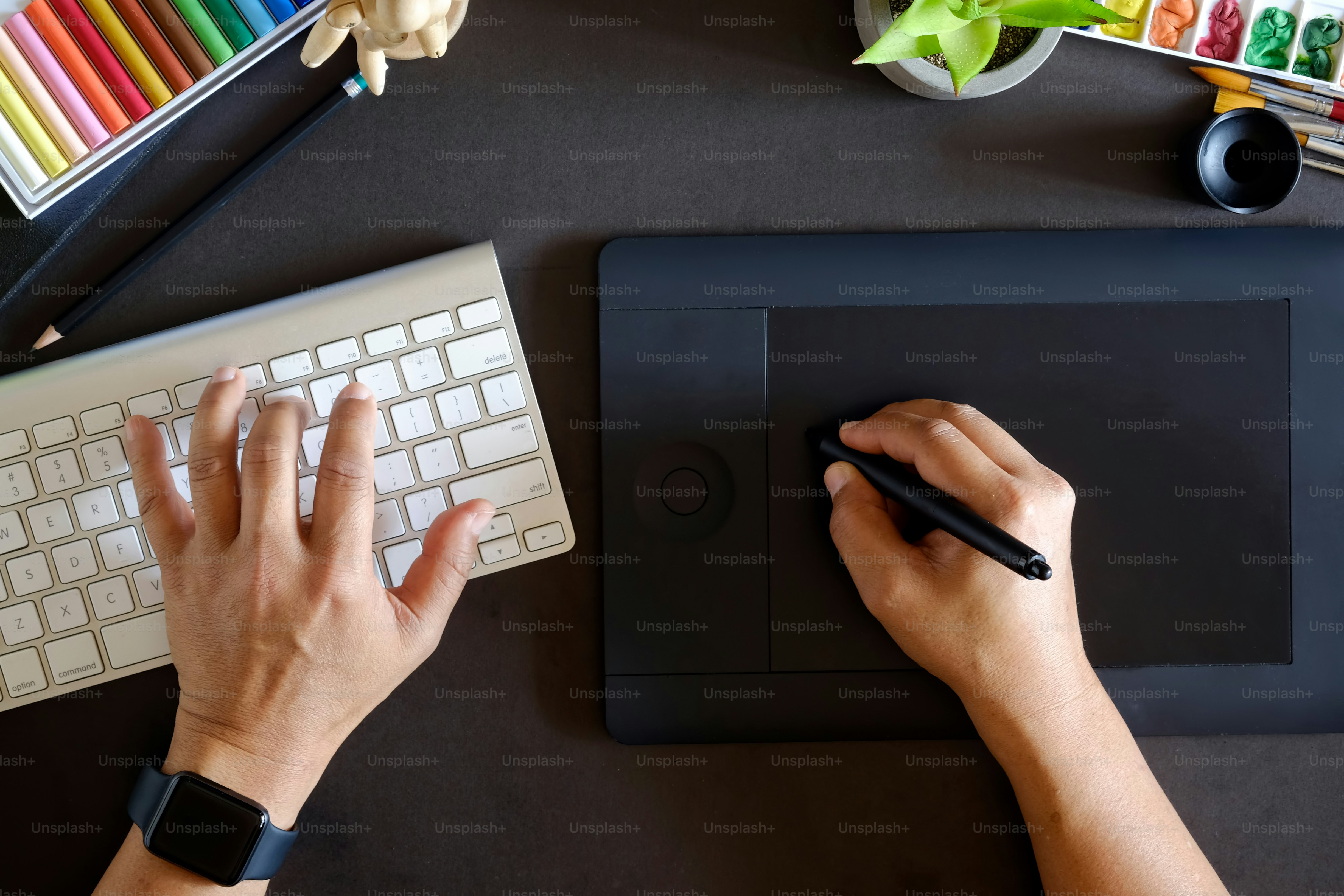 Top view Designer working with digital tablet and desktop computer at dark desk