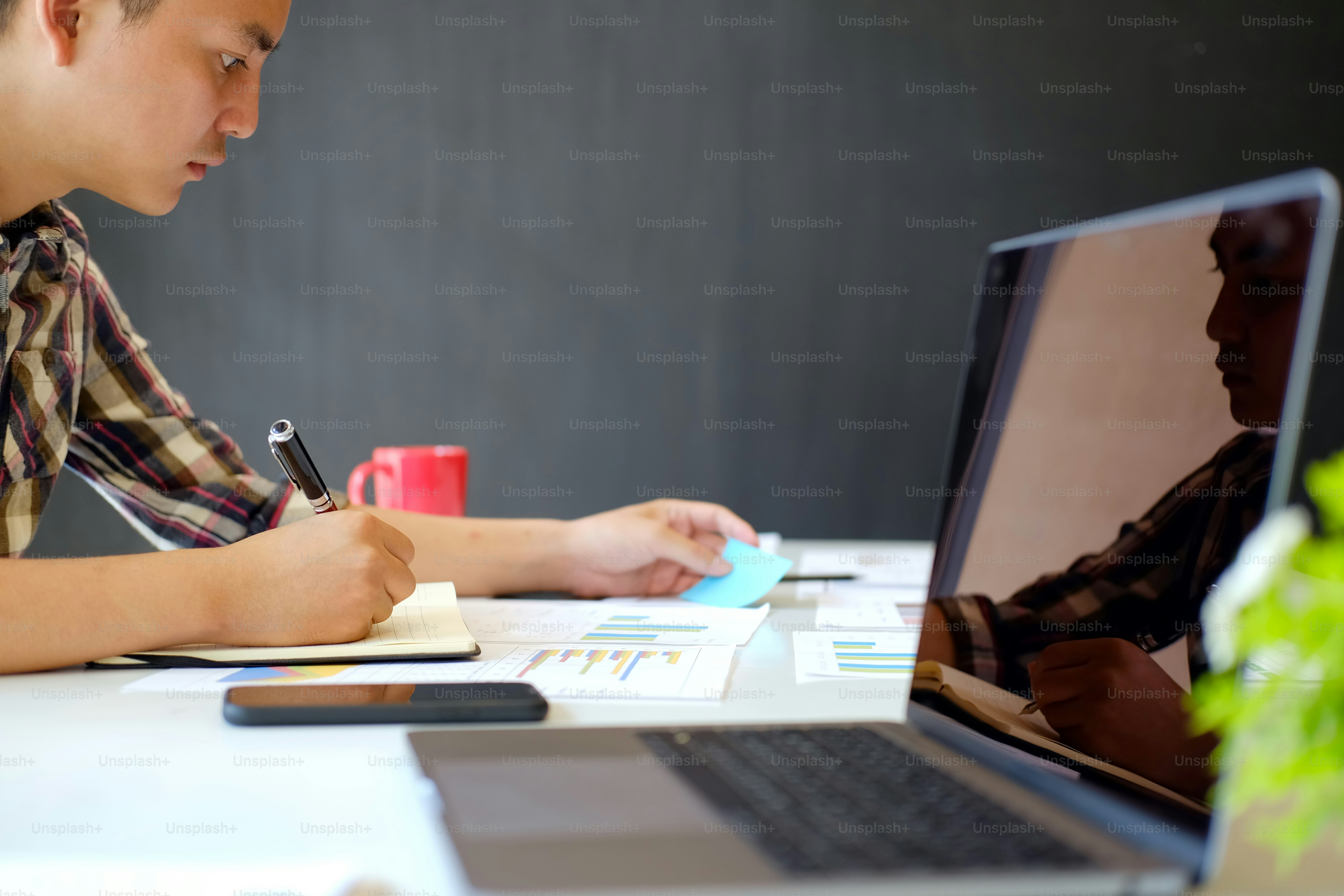Young workers working with new startup project in modern loft office. Business people working with new startup project in modern office.