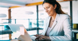 Young beautiful employee working on computer during working day in office