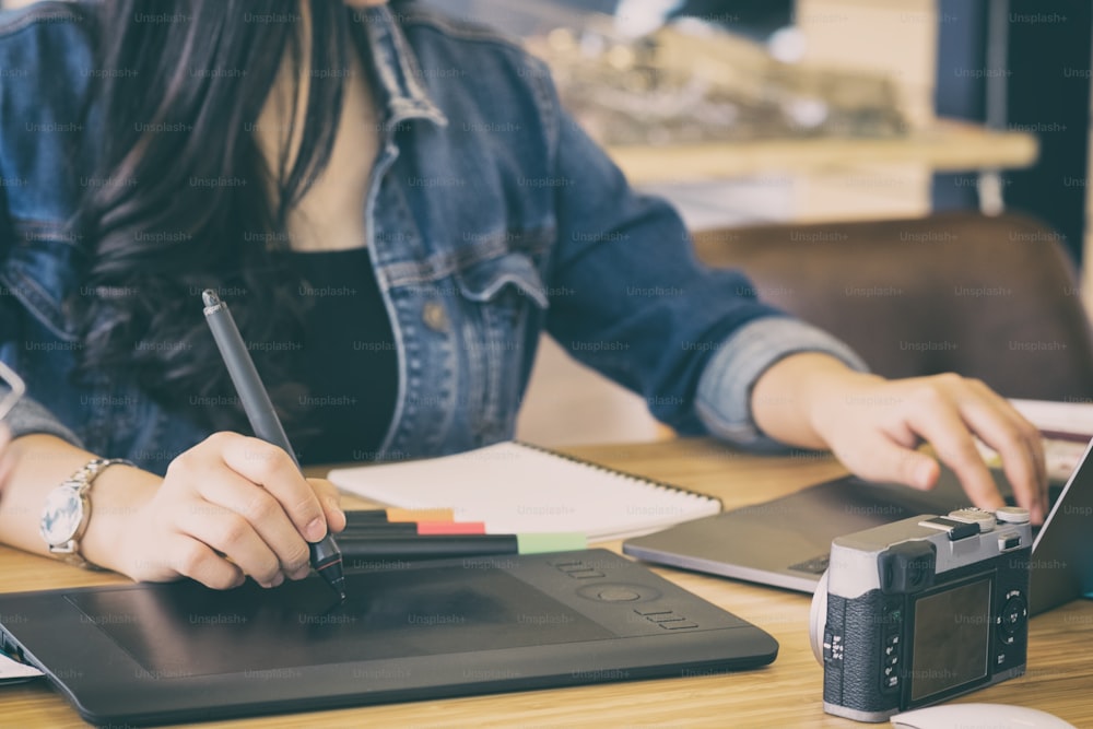 Freelance graphic designer working with mouse pen and computer on creative office.