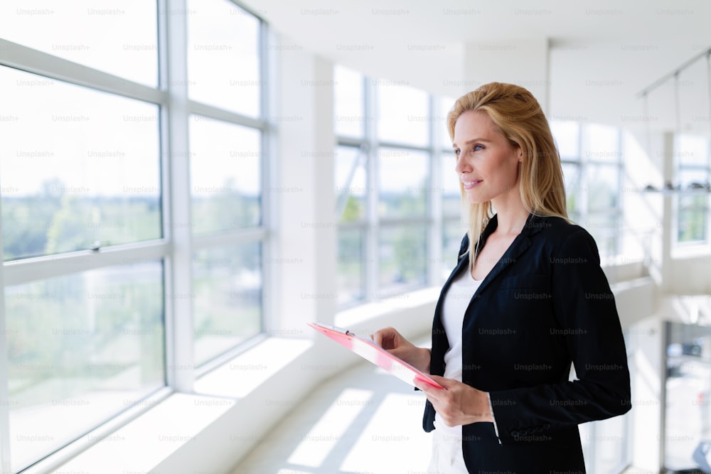 Picture of professional female salesperson working in car dealership