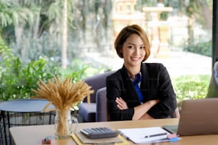 Shot of a businesswoman posing with her arms crossed in a home office.