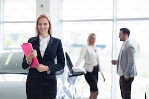 Picture of professional female salesperson working in car dealership