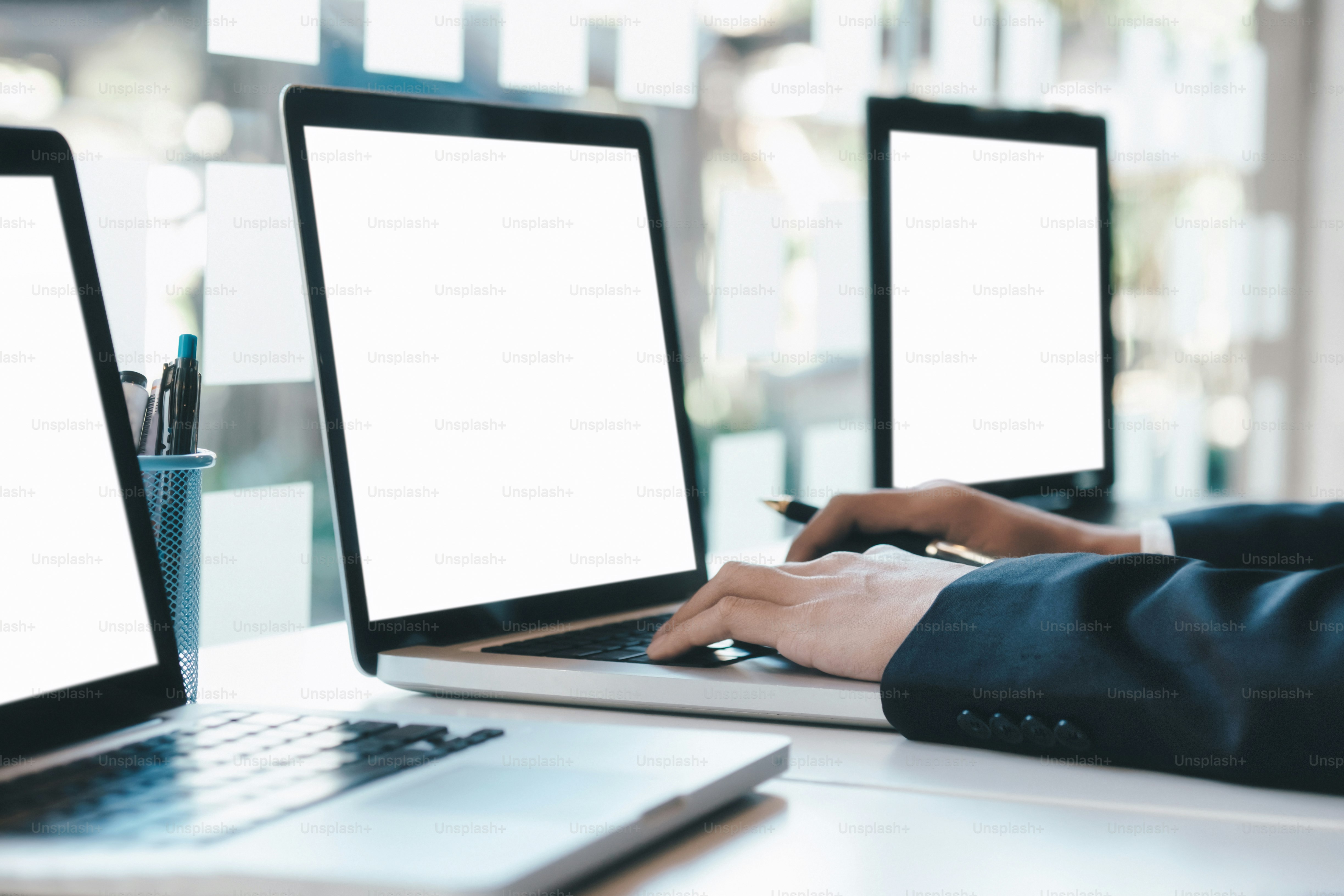 Businessman using computer to analyse the investment.