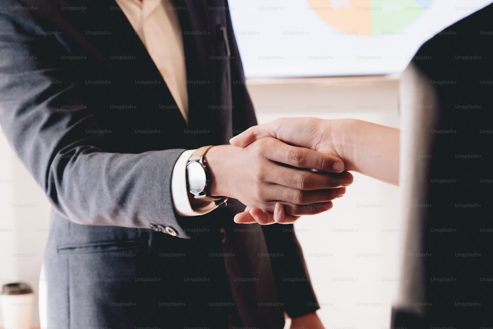 Close up of Business people shaking hands, finishing up meeting, business etiquette, congratulation, merger and acquisition concept