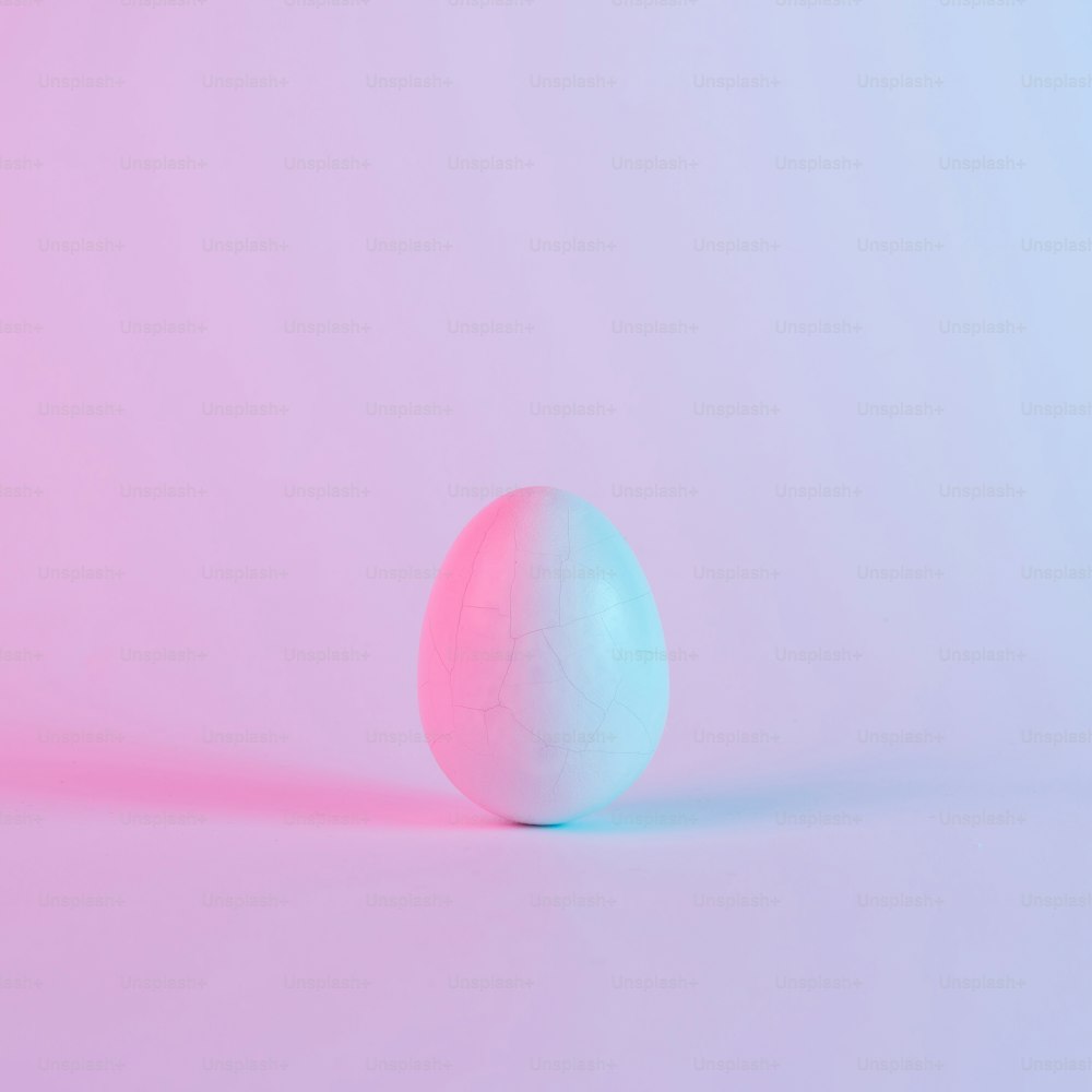 White Easter egg with colorful ultraviolet holographic neon lights. Creative concept.