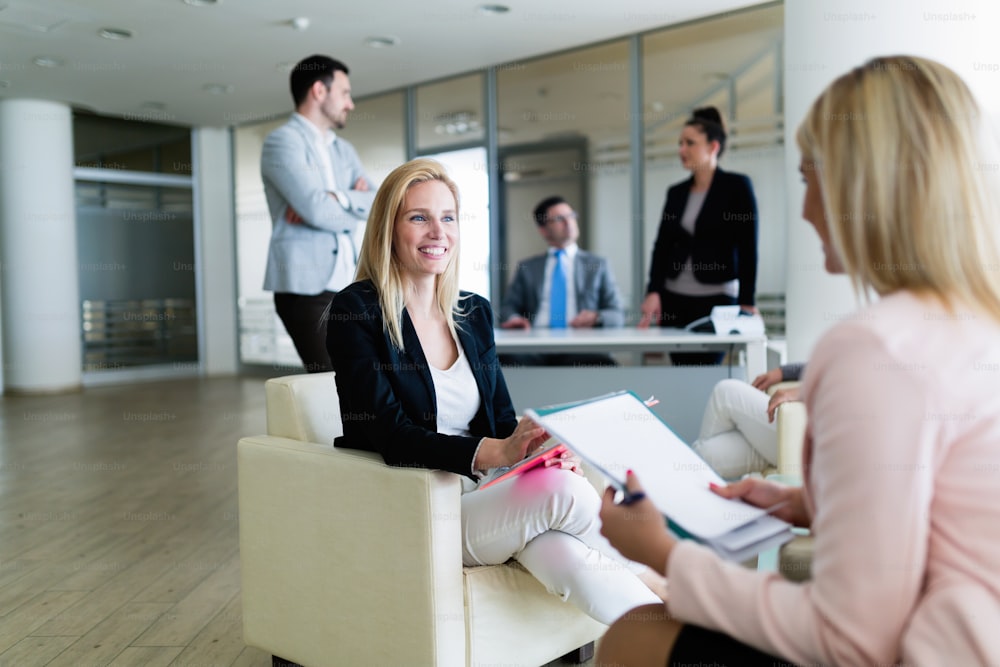 Picture of attractive smiling saleswoman working in office
