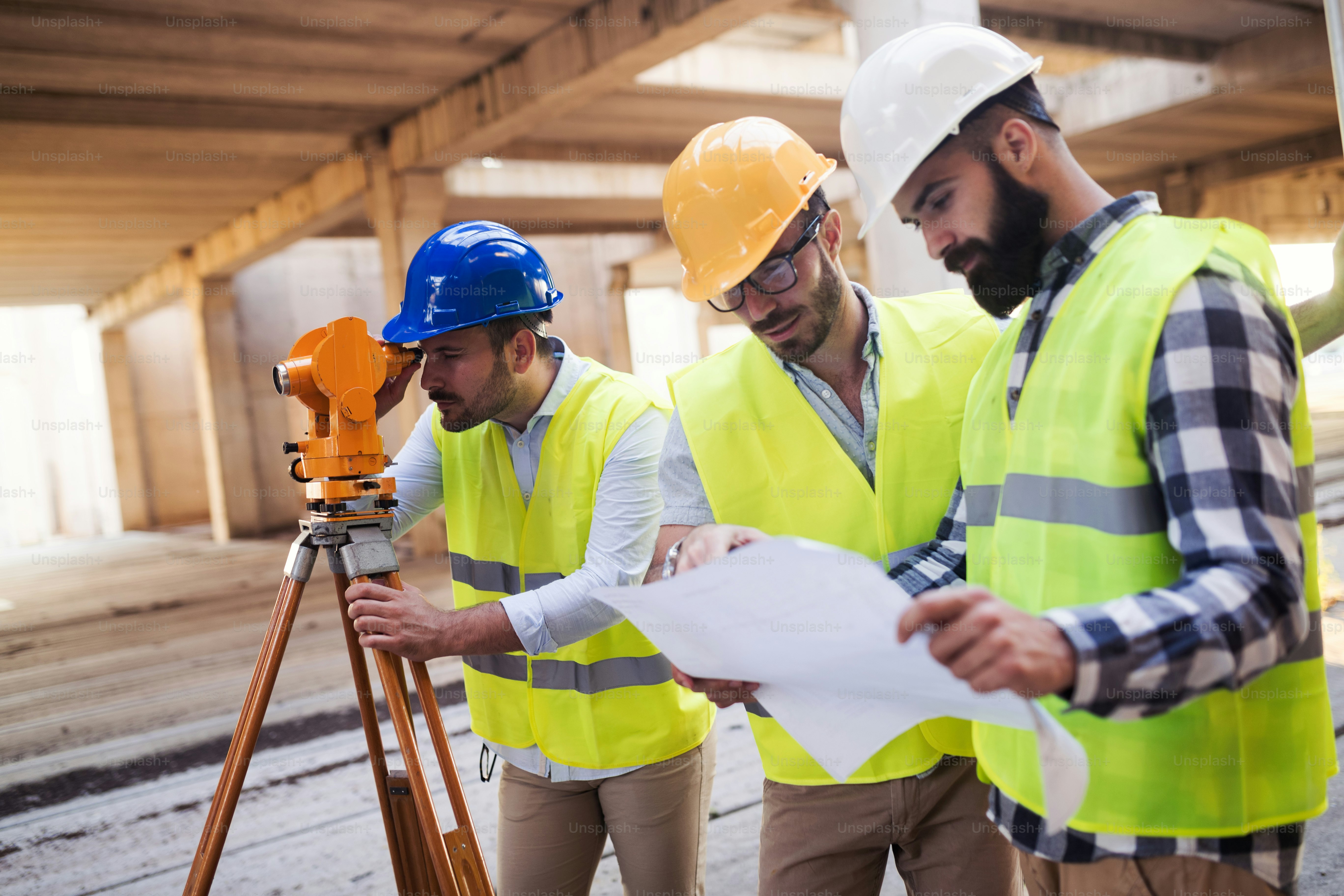 Portrait of construction engineers working on building site together
