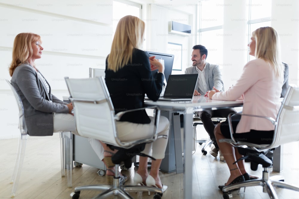 Picture of attractive smiling salesworkers on meeting in office