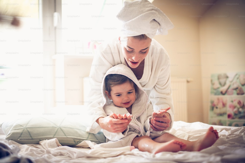 Mother and daughter have playing after bath.