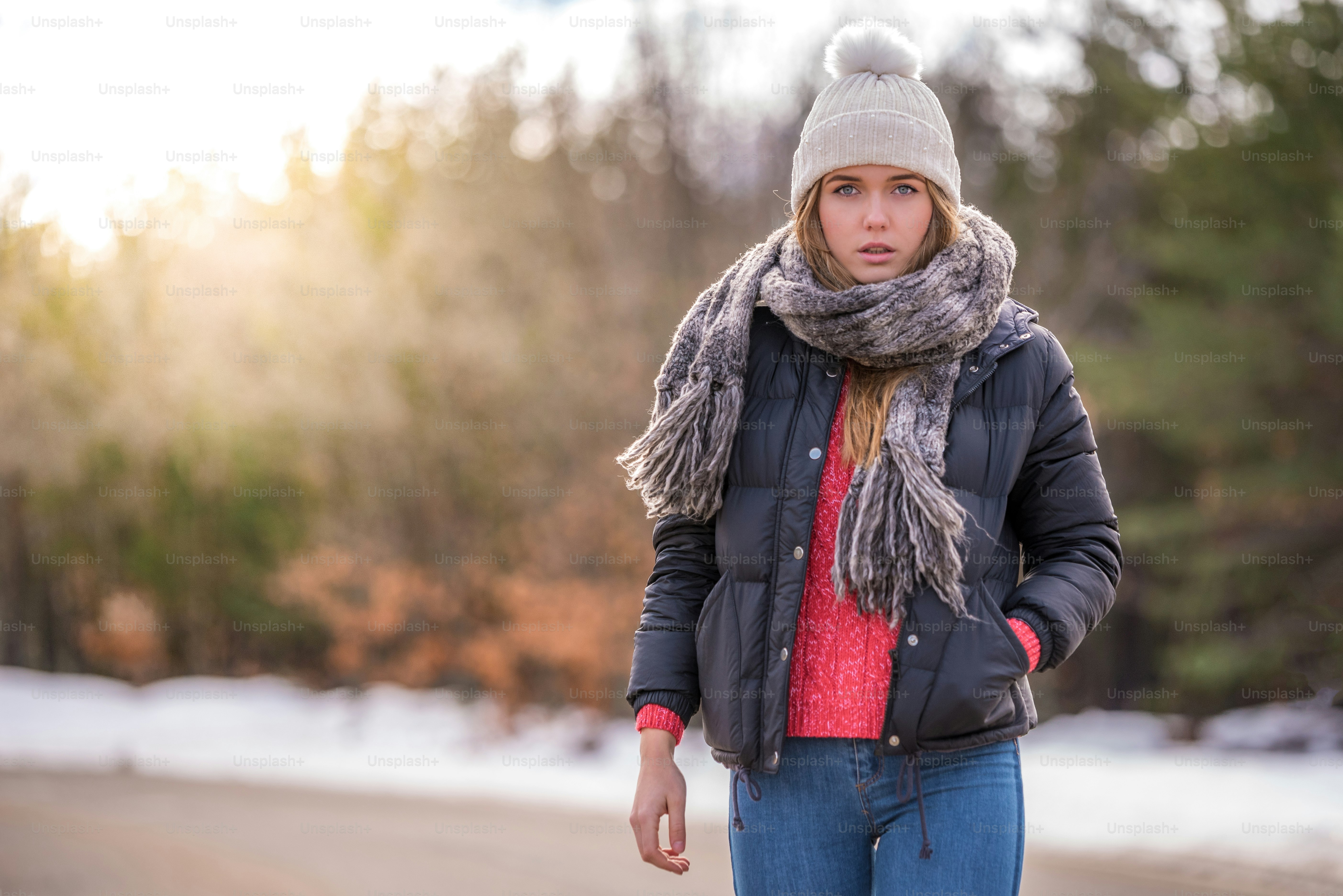 portrait Young pretty woman on a road with snow in winter