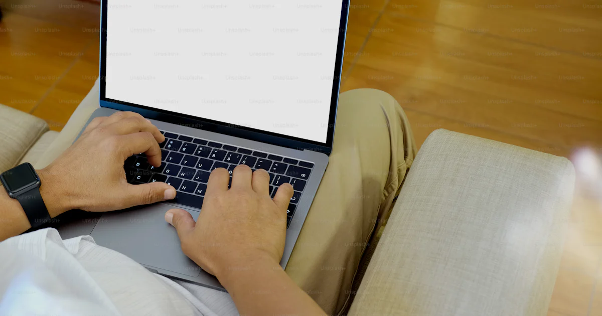 Unsplash Main Using Computer Closeup shot of an unidentifiable man using a laptop at home office ...