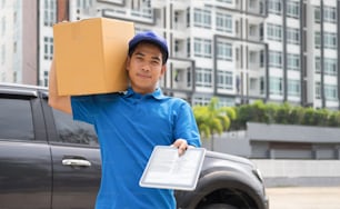 Deliver Service, Mailing and Logistic Concept.Young Delivery Man Checking Customer List On Tablet.