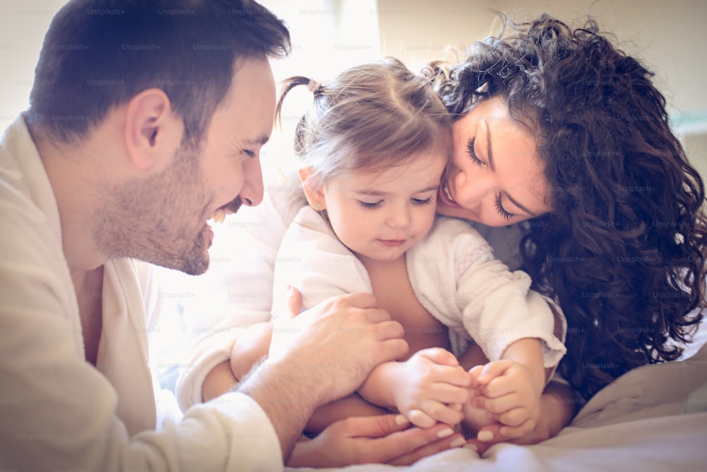Happy parents with their little girl. Portrait.