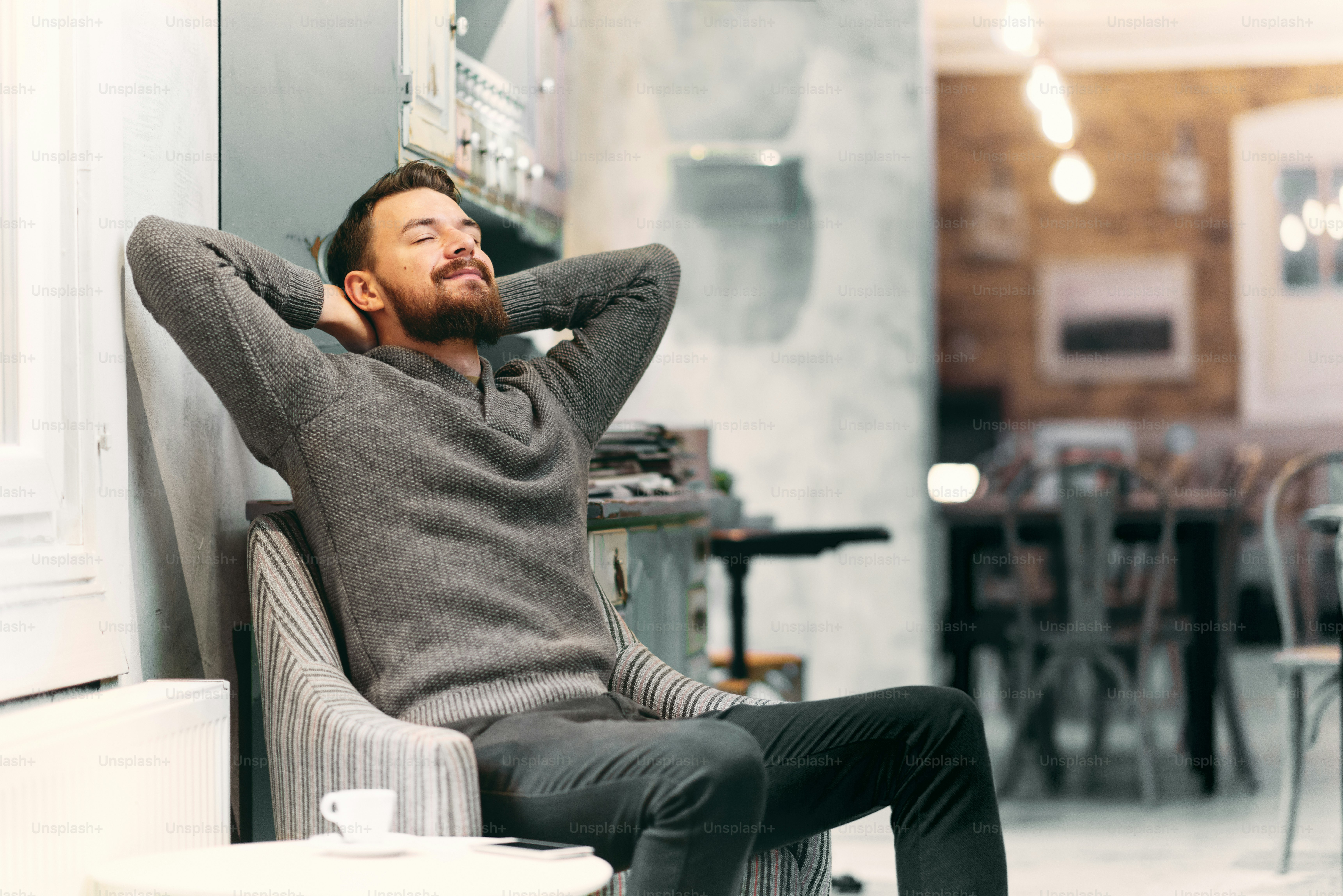 Man resting in the chair at cafe.