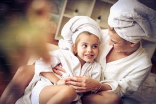 Portrait of mother and daughter after bath. Focus on daughter.