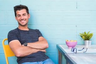 Happy young man seating in a restaurant
