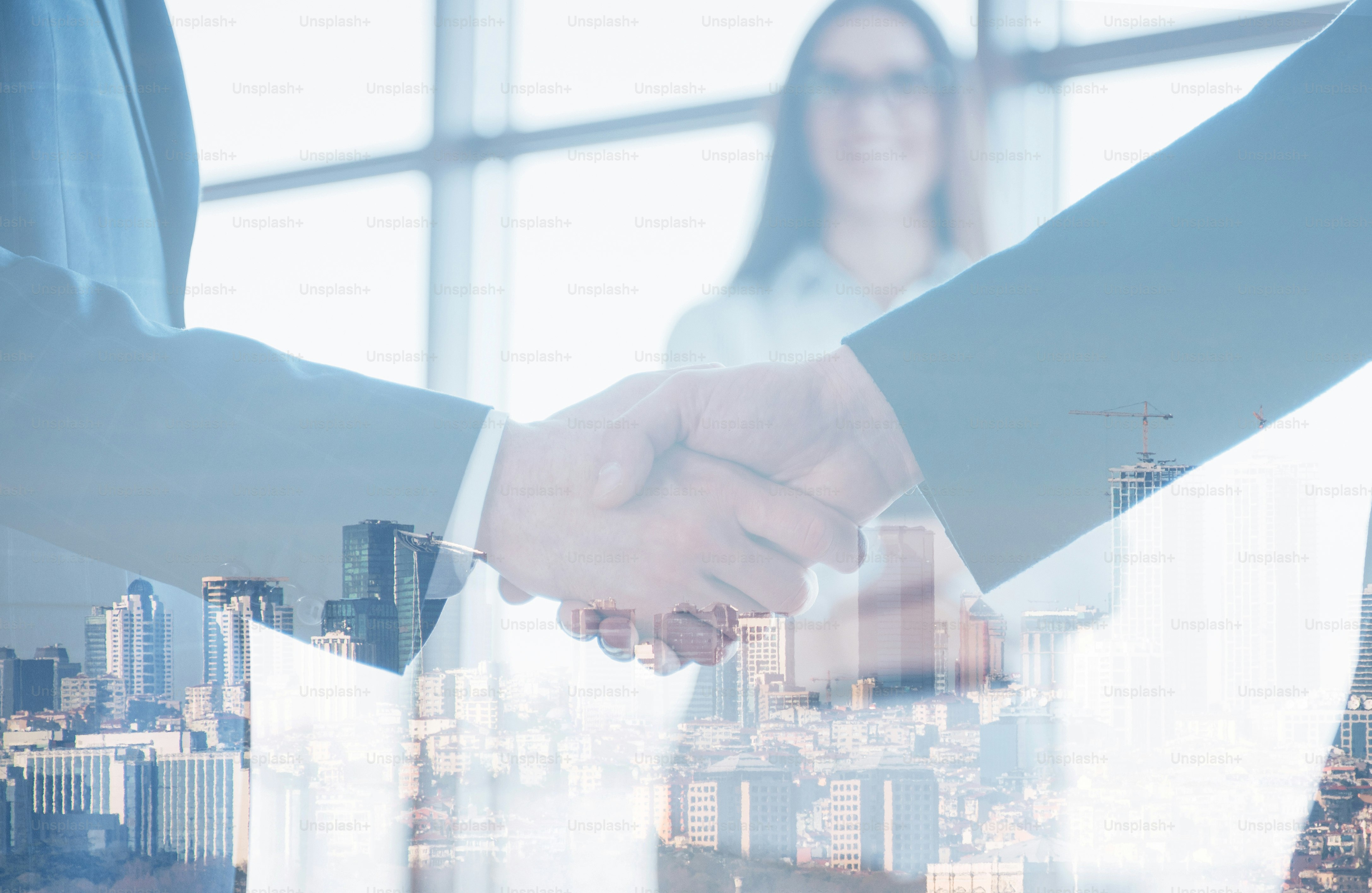 Business handshake over city panorama evoking negotiated coordination